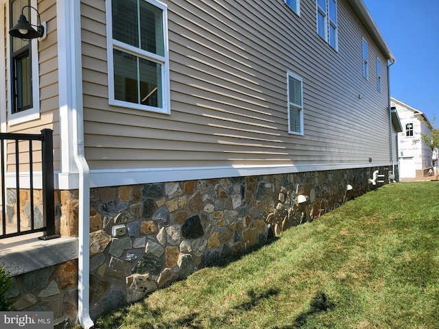 view of home's exterior with a lawn