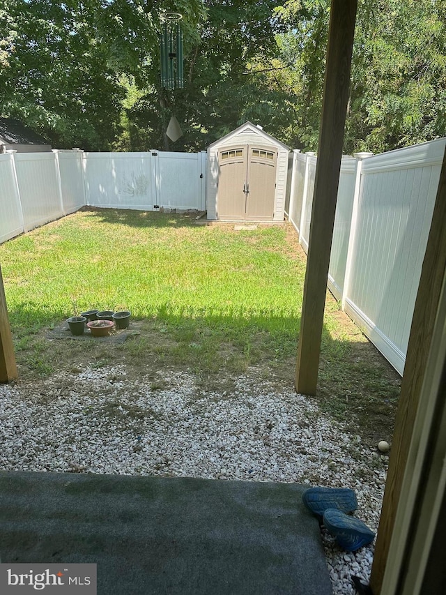 view of yard featuring a shed and an outdoor fire pit