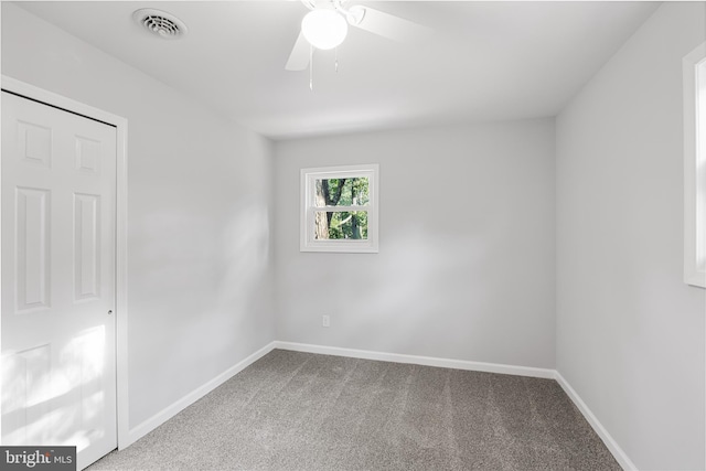 unfurnished room featuring ceiling fan and carpet floors