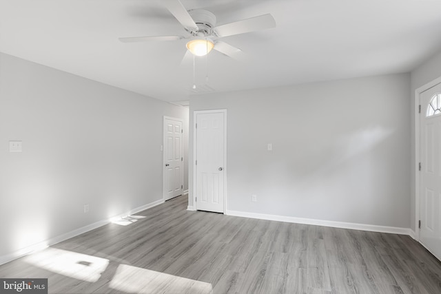 empty room featuring ceiling fan and light wood-type flooring