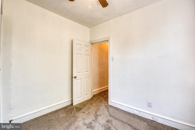 empty room with carpet flooring and ceiling fan