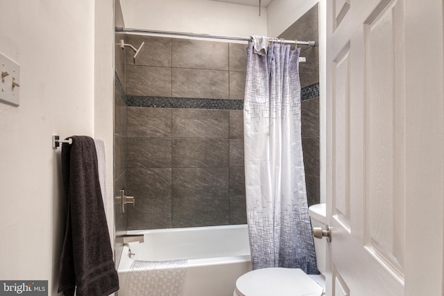 bathroom featuring toilet and shower / bathtub combination with curtain