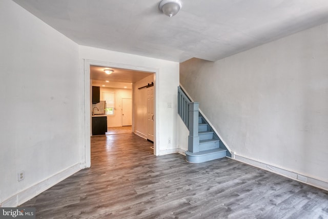 empty room featuring hardwood / wood-style floors and a barn door