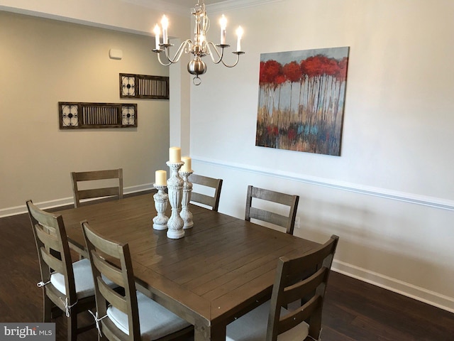 dining room with dark hardwood / wood-style flooring and a chandelier