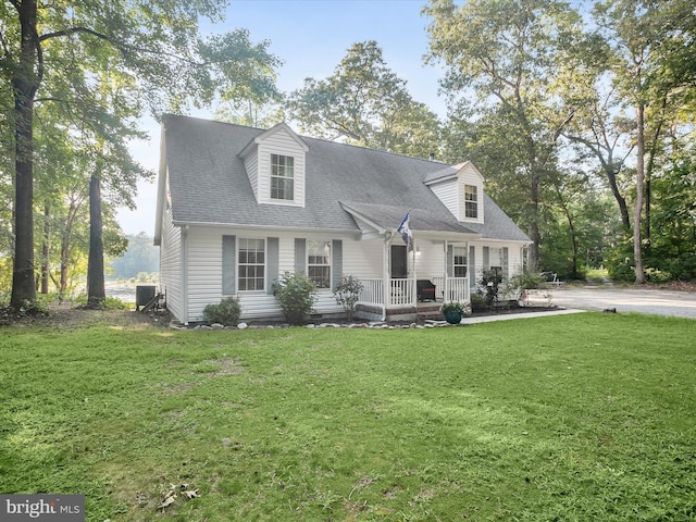 cape cod-style house with central AC unit, a front lawn, and a porch