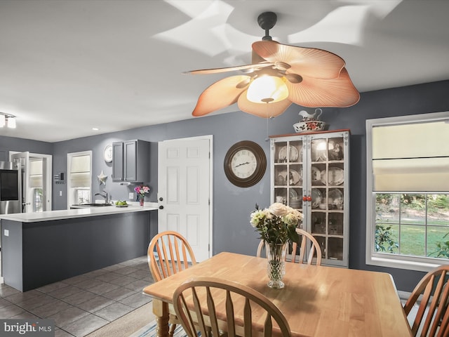 dining area with sink and tile patterned floors