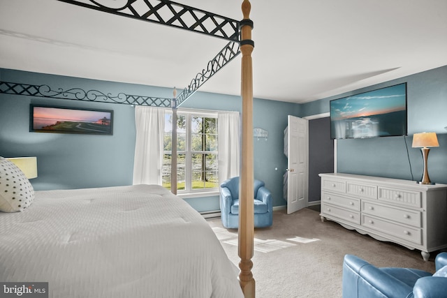 bedroom featuring a baseboard heating unit and carpet flooring