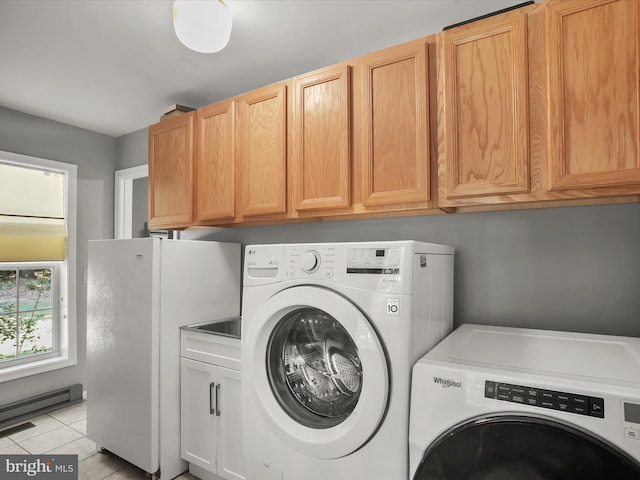 laundry area with cabinets, light tile patterned floors, a baseboard heating unit, and washing machine and clothes dryer