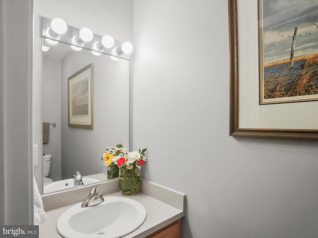 bathroom with toilet and vanity