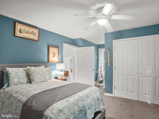 carpeted bedroom featuring ceiling fan, a closet, and lofted ceiling