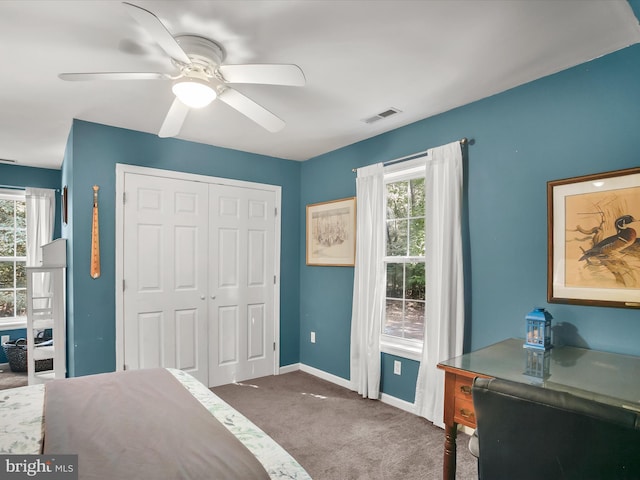 bedroom featuring ceiling fan, carpet, and a closet