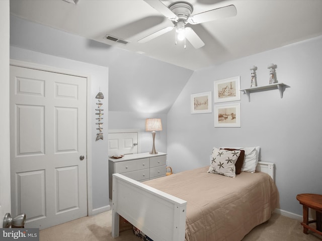 bedroom with ceiling fan, lofted ceiling, and light colored carpet