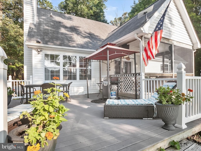 deck with an outdoor hangout area, a grill, and a sunroom