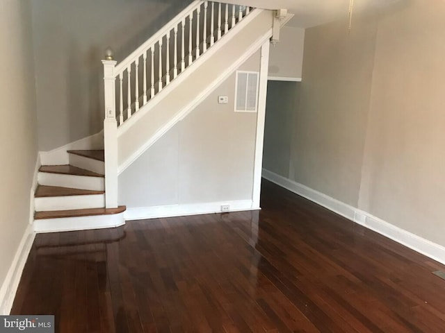 staircase with wood-type flooring