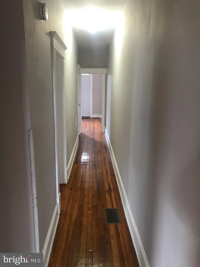 hall with dark wood-type flooring