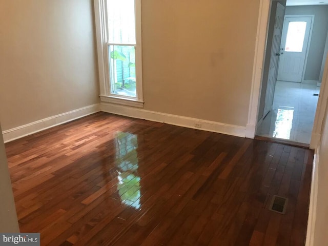 unfurnished room with dark hardwood / wood-style floors