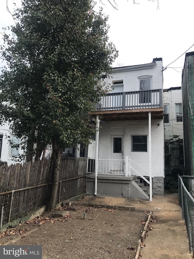 rear view of property with a balcony