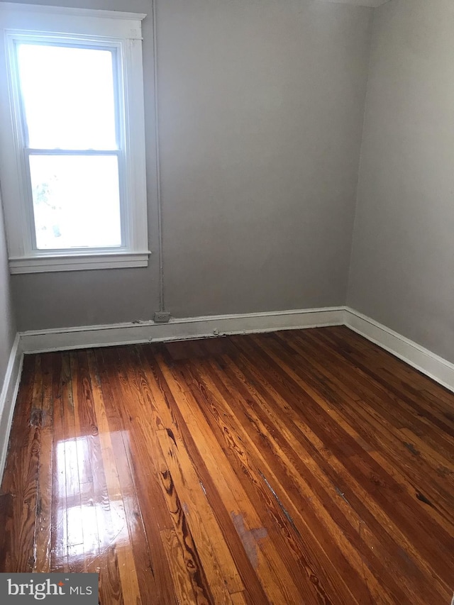 empty room featuring dark hardwood / wood-style flooring