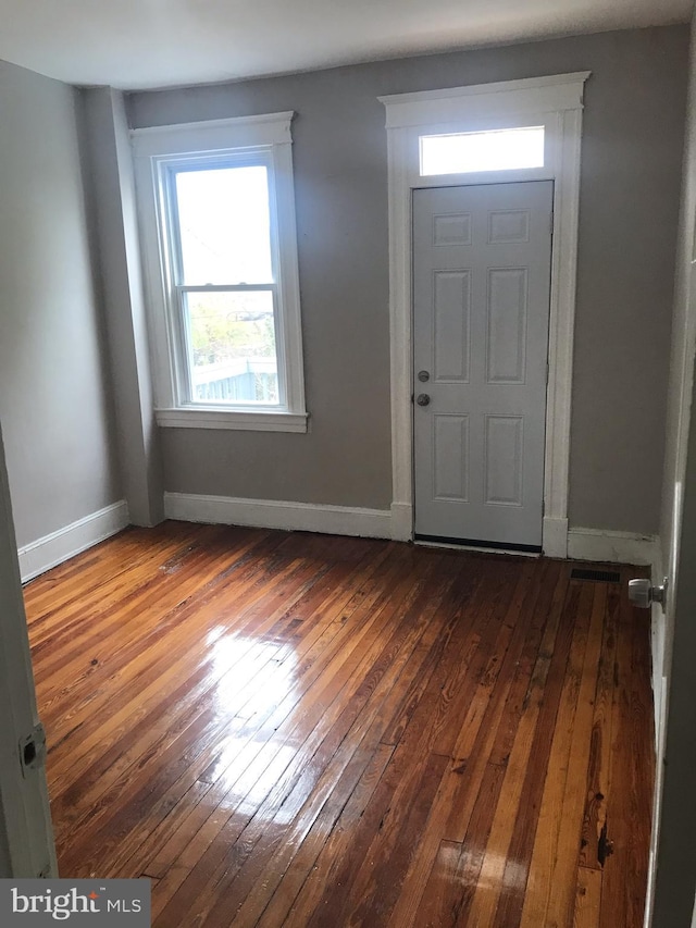 entryway with dark hardwood / wood-style flooring