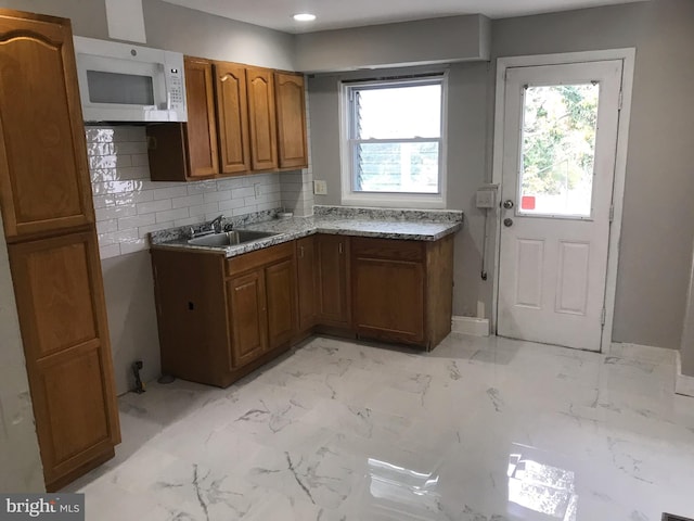 kitchen featuring tasteful backsplash and sink