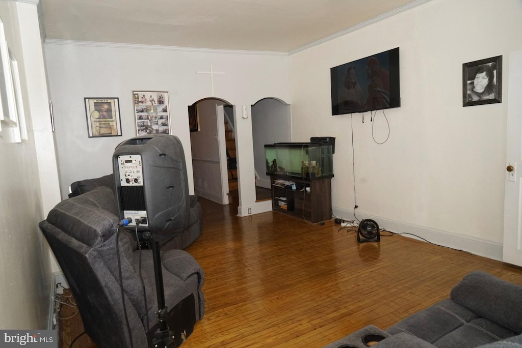 living room with hardwood / wood-style flooring and ornamental molding