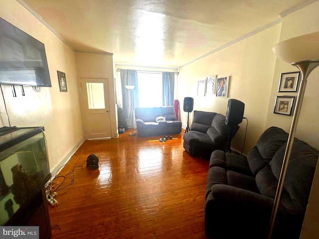 living room with wood-type flooring and ornamental molding