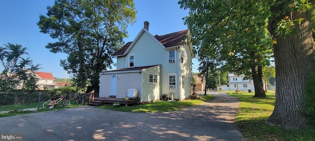 view of side of property with a deck