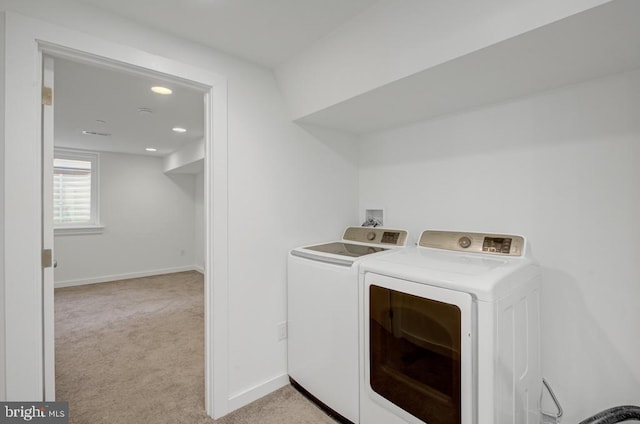 laundry area with light colored carpet and separate washer and dryer