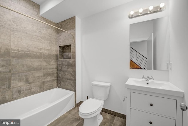 full bathroom featuring tiled shower / bath combo, toilet, and vanity