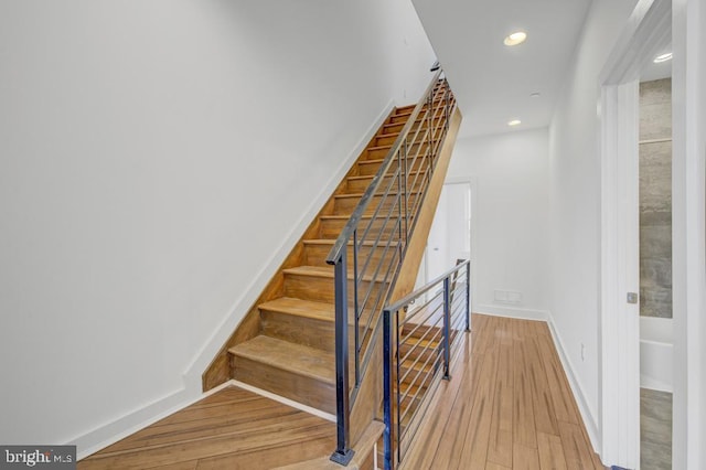 stairs with hardwood / wood-style floors