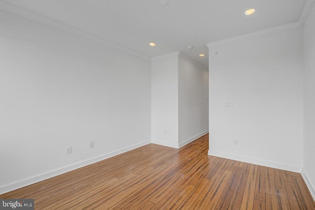 empty room featuring light hardwood / wood-style floors and crown molding