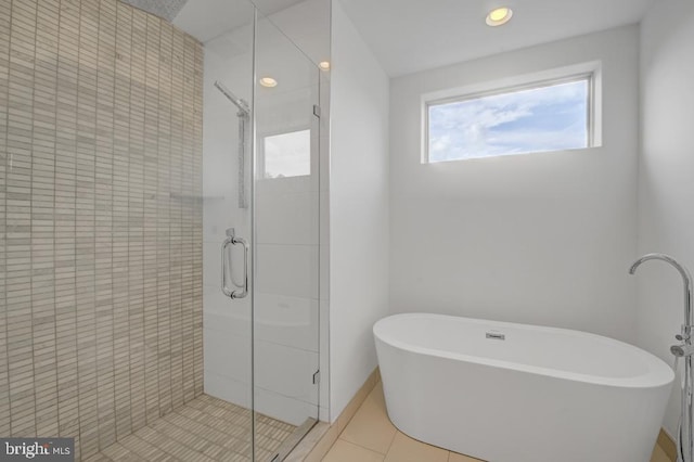 bathroom featuring tile patterned floors and independent shower and bath