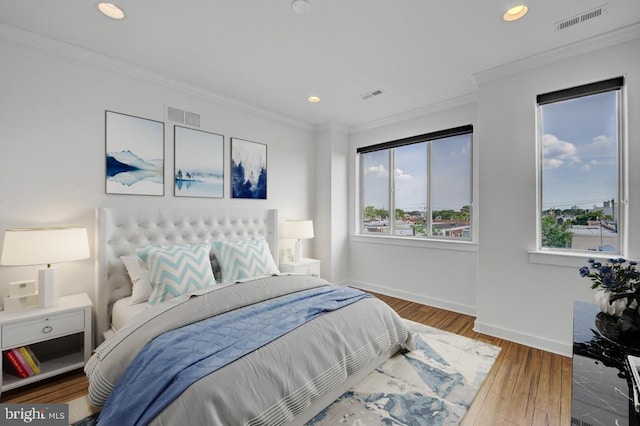 bedroom with hardwood / wood-style flooring and ornamental molding