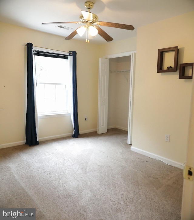 unfurnished bedroom with light carpet, ceiling fan, and a closet