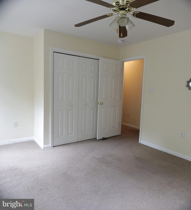 unfurnished bedroom with light carpet, ceiling fan, and a closet