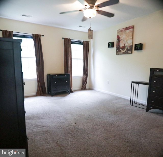 unfurnished room featuring ceiling fan, carpet, and plenty of natural light