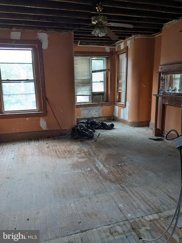 interior space featuring ceiling fan, cooling unit, and hardwood / wood-style flooring