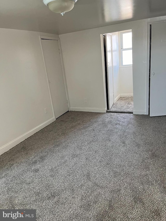 unfurnished room featuring carpet