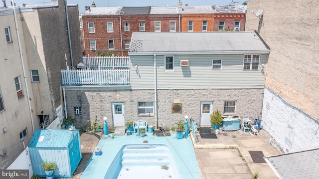 rear view of house with a patio and a balcony