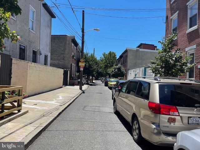 view of street with street lighting, curbs, and sidewalks