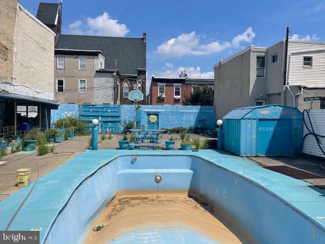 view of pool with a hot tub