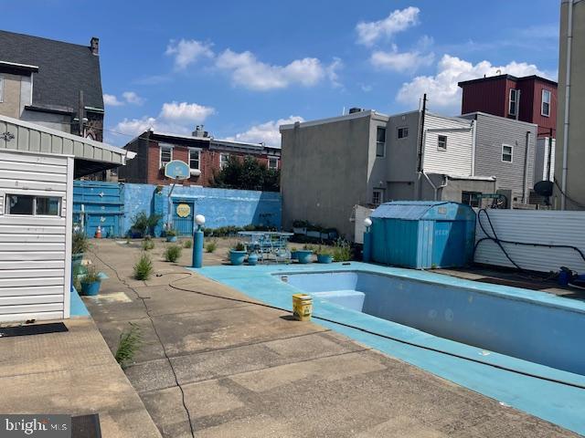 view of pool with a patio area, fence, and a pool