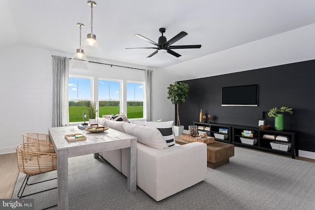 living room featuring lofted ceiling, wood-type flooring, and ceiling fan