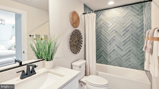 full bathroom featuring shower / bath combo with shower curtain, toilet, and vanity