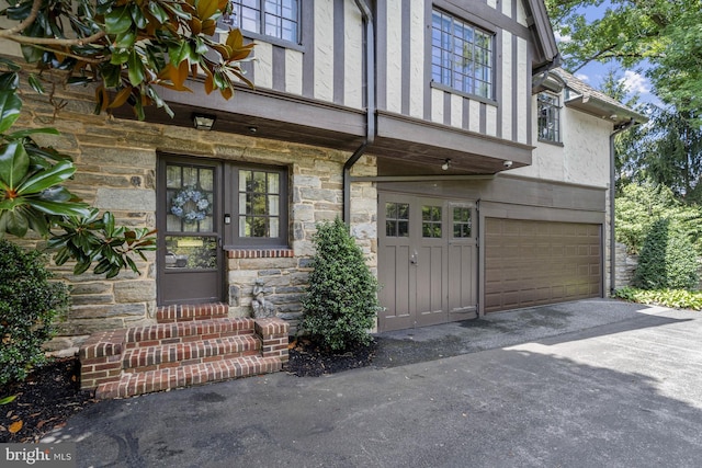 view of exterior entry with a garage