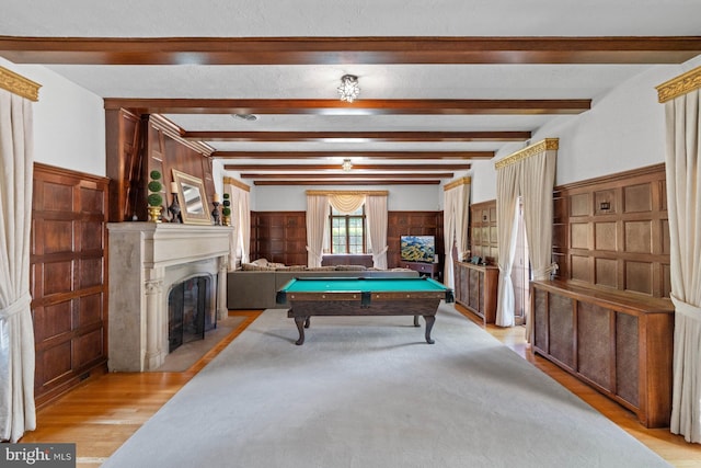 recreation room featuring pool table, beam ceiling, and light wood-type flooring