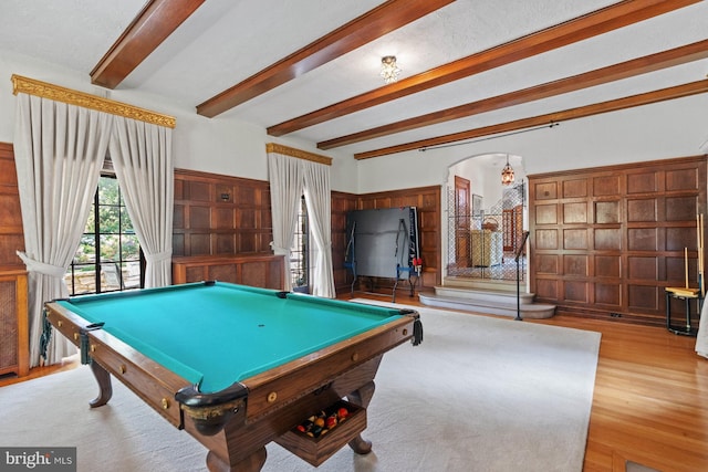 game room featuring beamed ceiling and light wood-type flooring