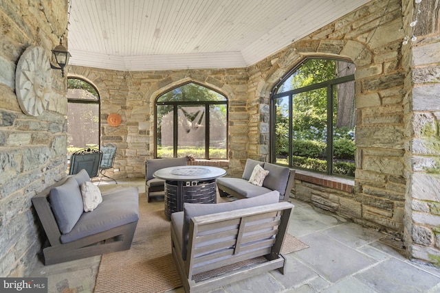 view of patio featuring an outdoor living space with a fire pit