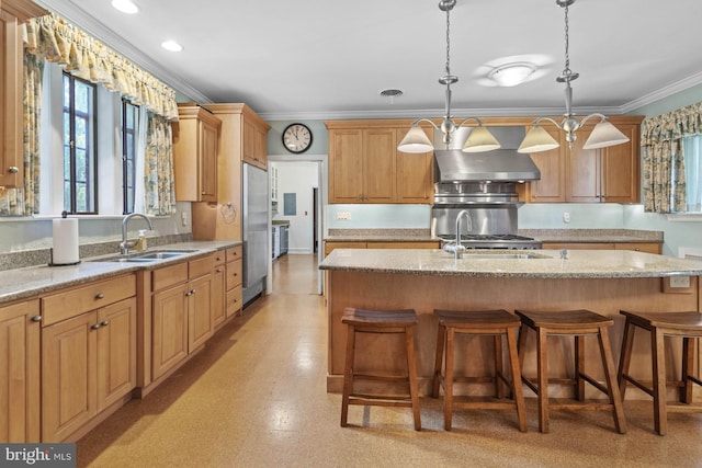 kitchen featuring sink, ventilation hood, hanging light fixtures, and a center island with sink