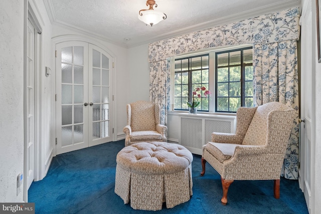 living area featuring radiator heating unit, ornamental molding, a textured ceiling, dark carpet, and french doors